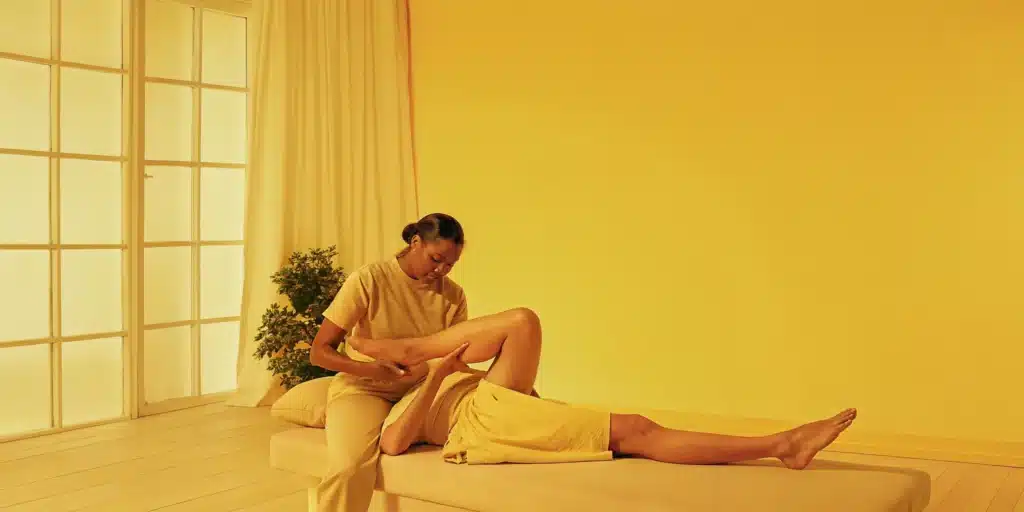 Therapist performing 1-on-1 assisted stretching on client.