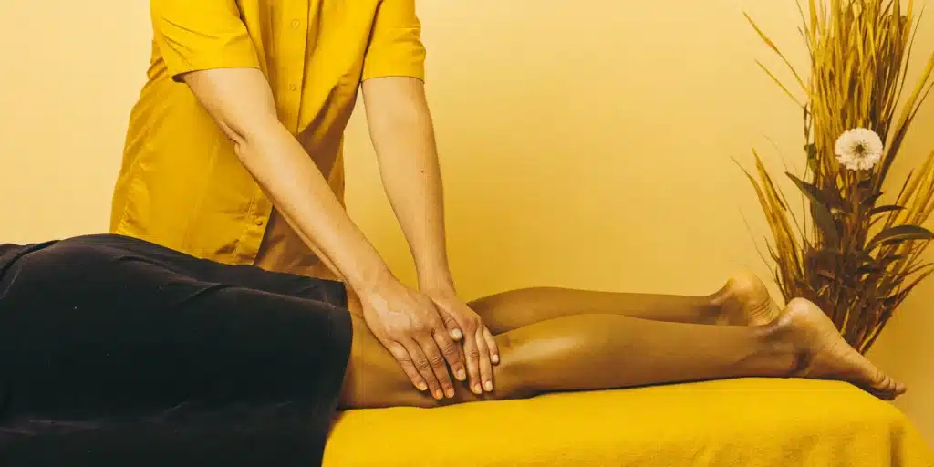 Physical therapist assessing a patient's leg for contraindications of stretching.