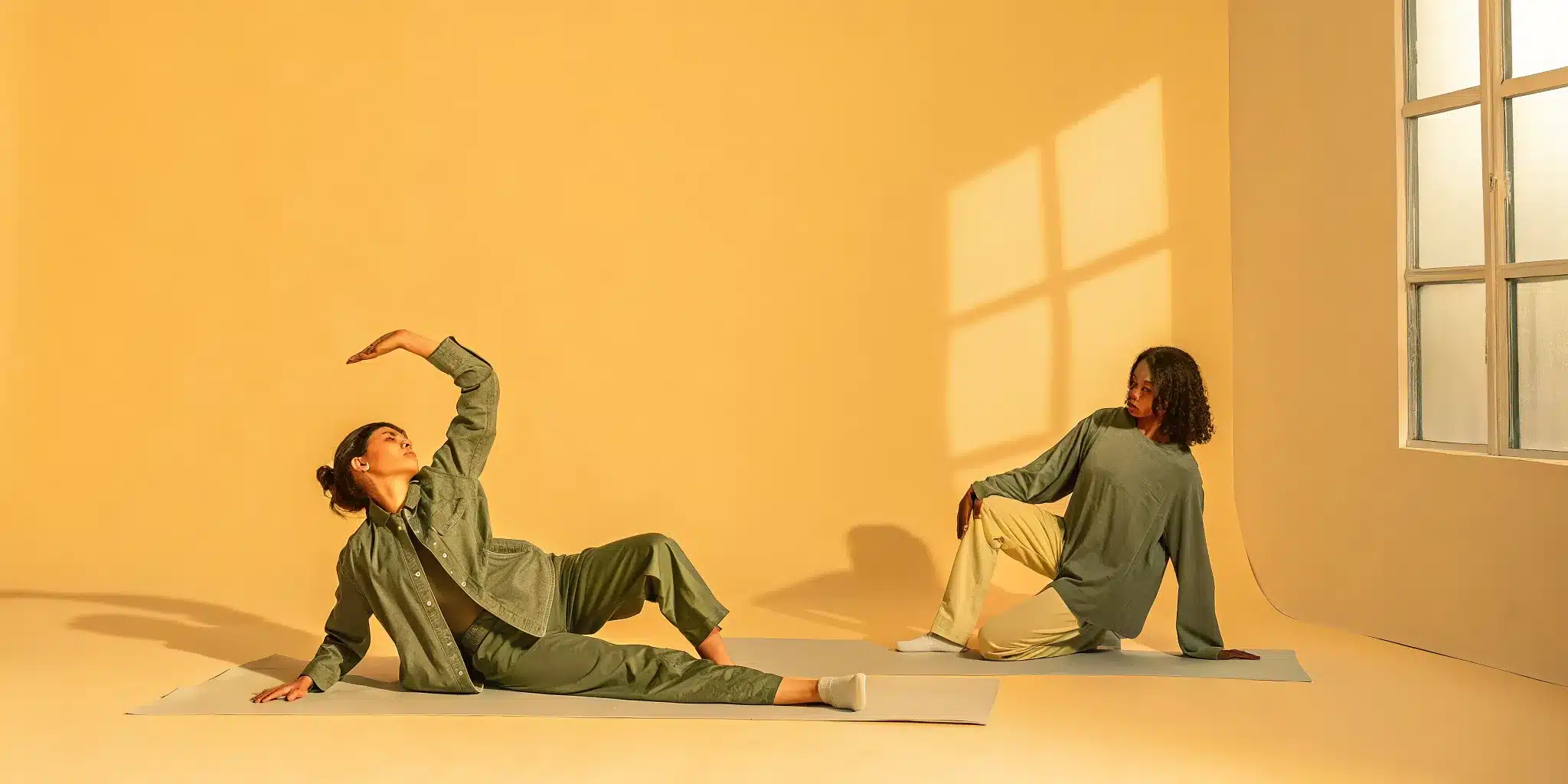 Two women demonstrate dynamic vs static stretching on yoga mats.