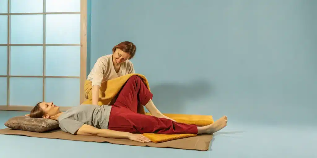 A professional performs an assisted stretch to loosen tight leg muscles.