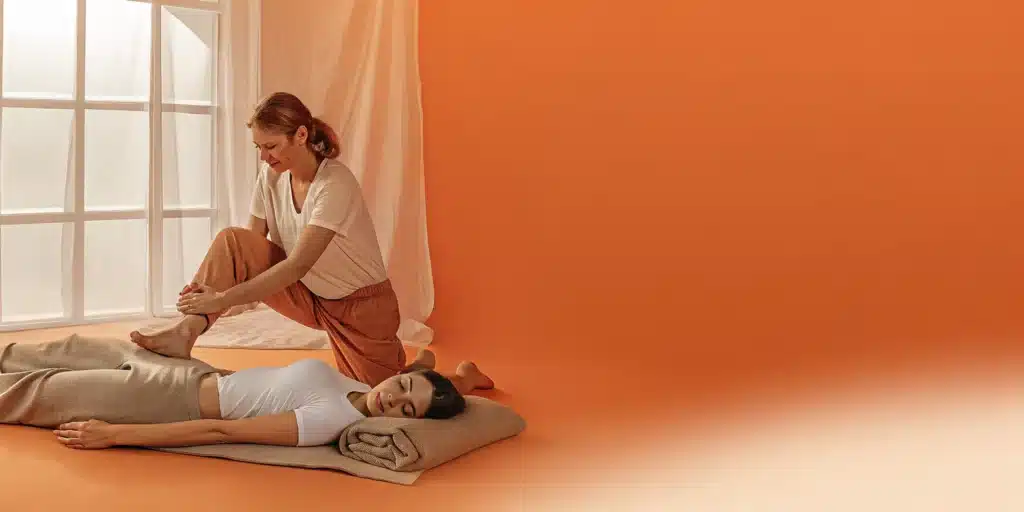 Professional assisted stretching to relieve stiffness in thighs and legs.