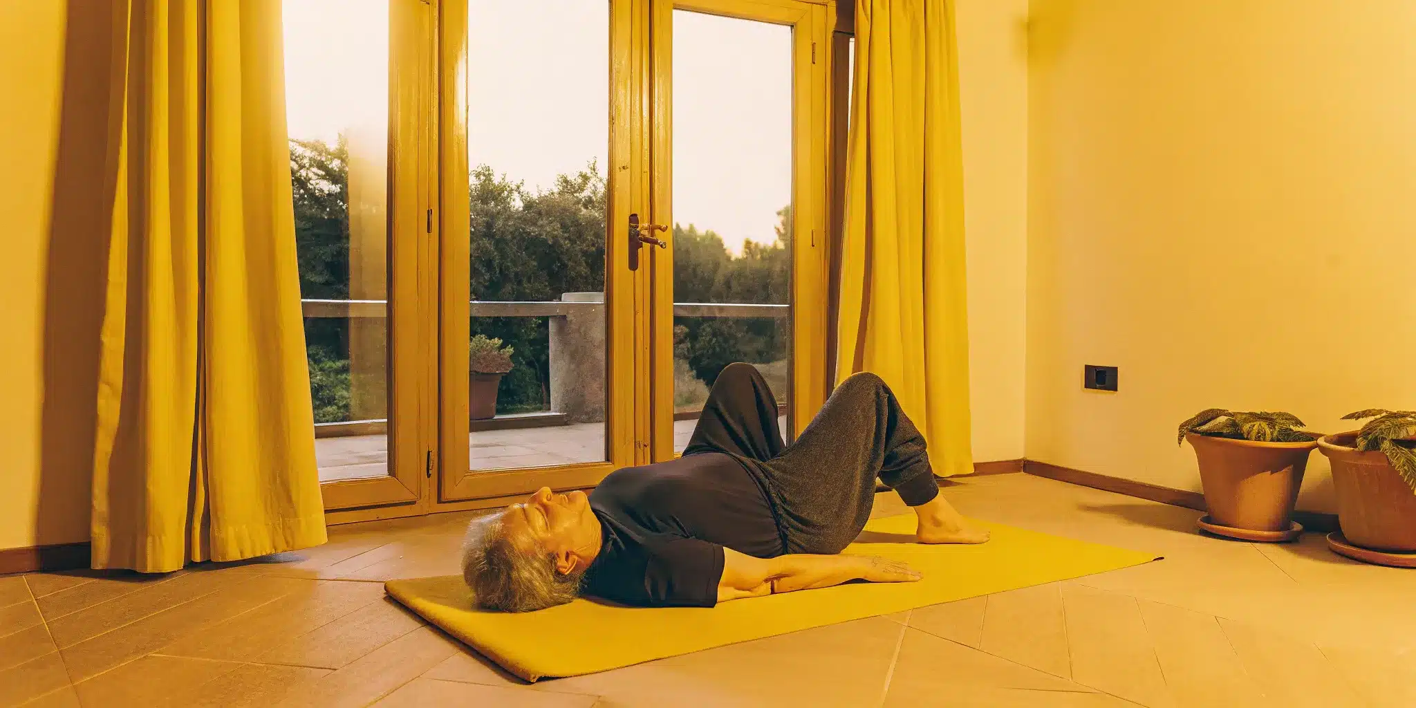 Older adult doing a gentle floor stretch to combat age-related stiffness.