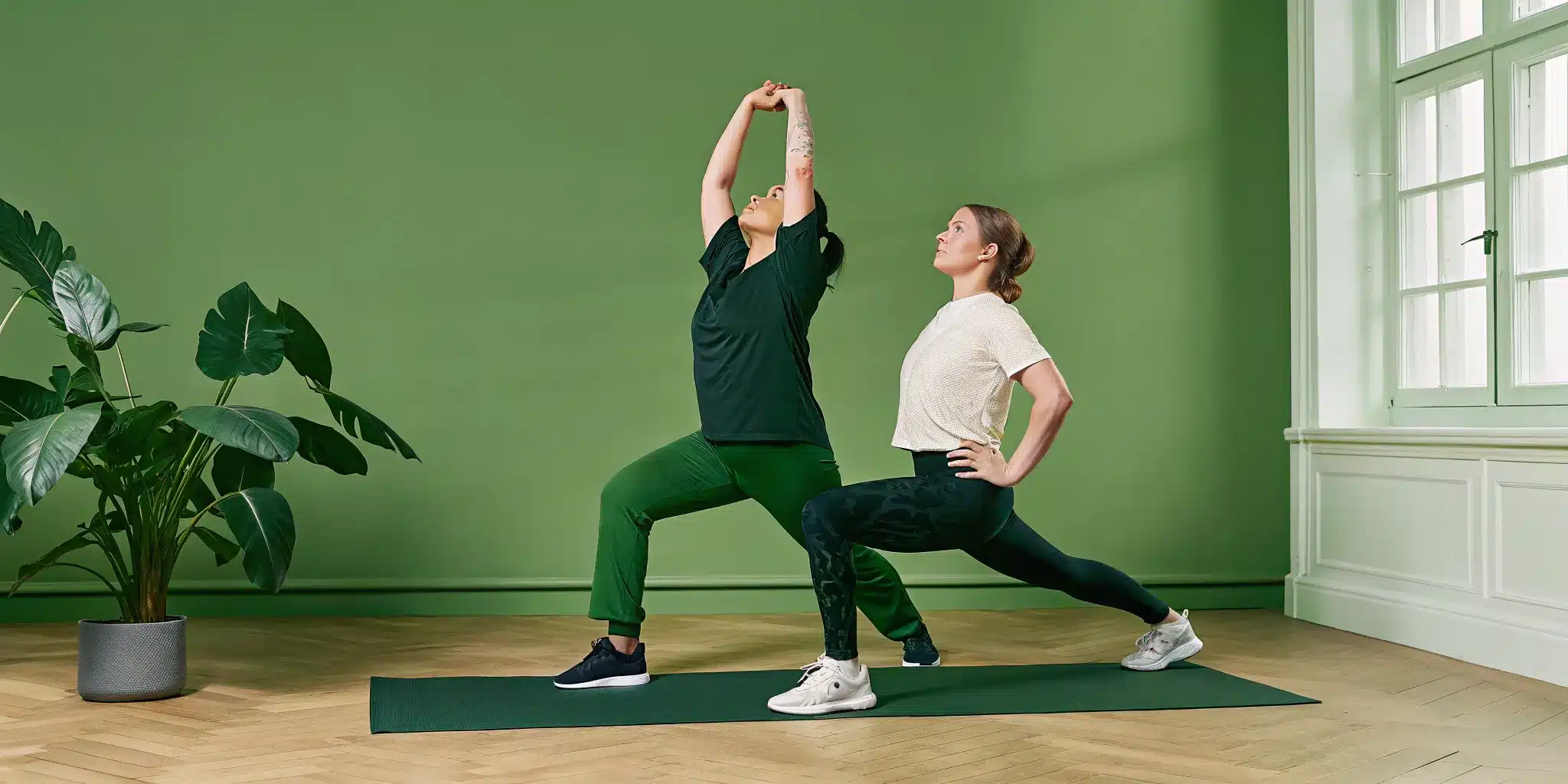 A dynamic stretching warm up with two women doing exercises on mats.