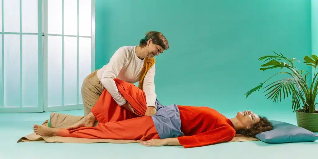 A person receives a partner-assisted PNF stretch, a technique for improving flexibility and mobility.