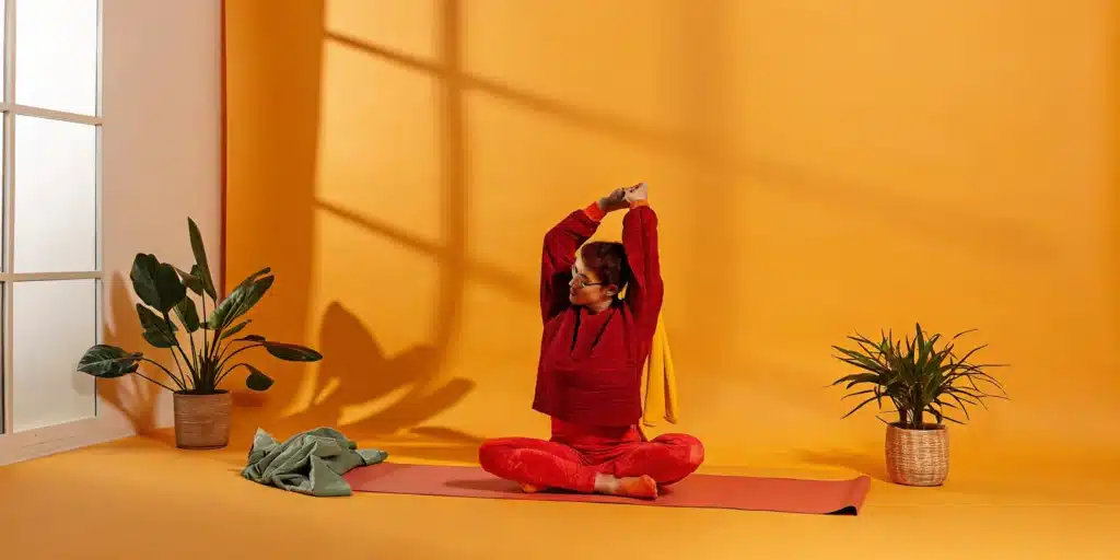 Woman holding a deep stretch for flexibility on a yoga mat.