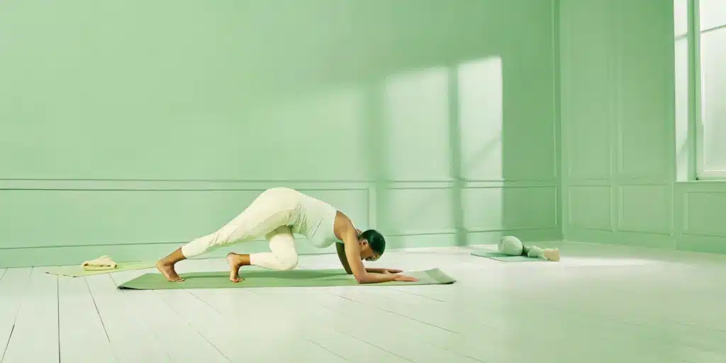 Woman performing a hip mobility stretch for deeper squats.